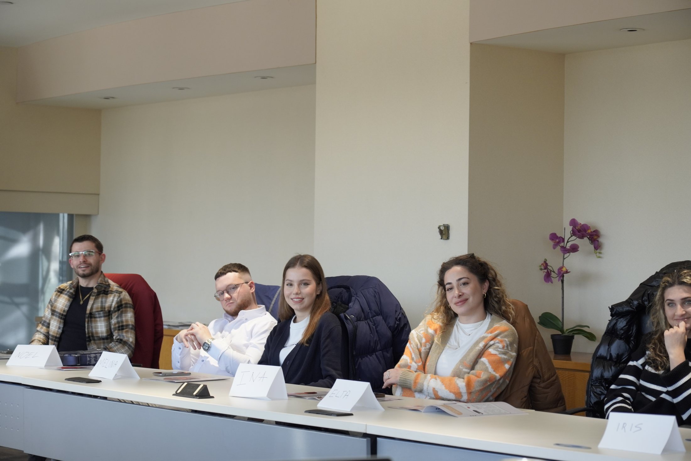 Albanian Youth community participants seated together around a meeting table