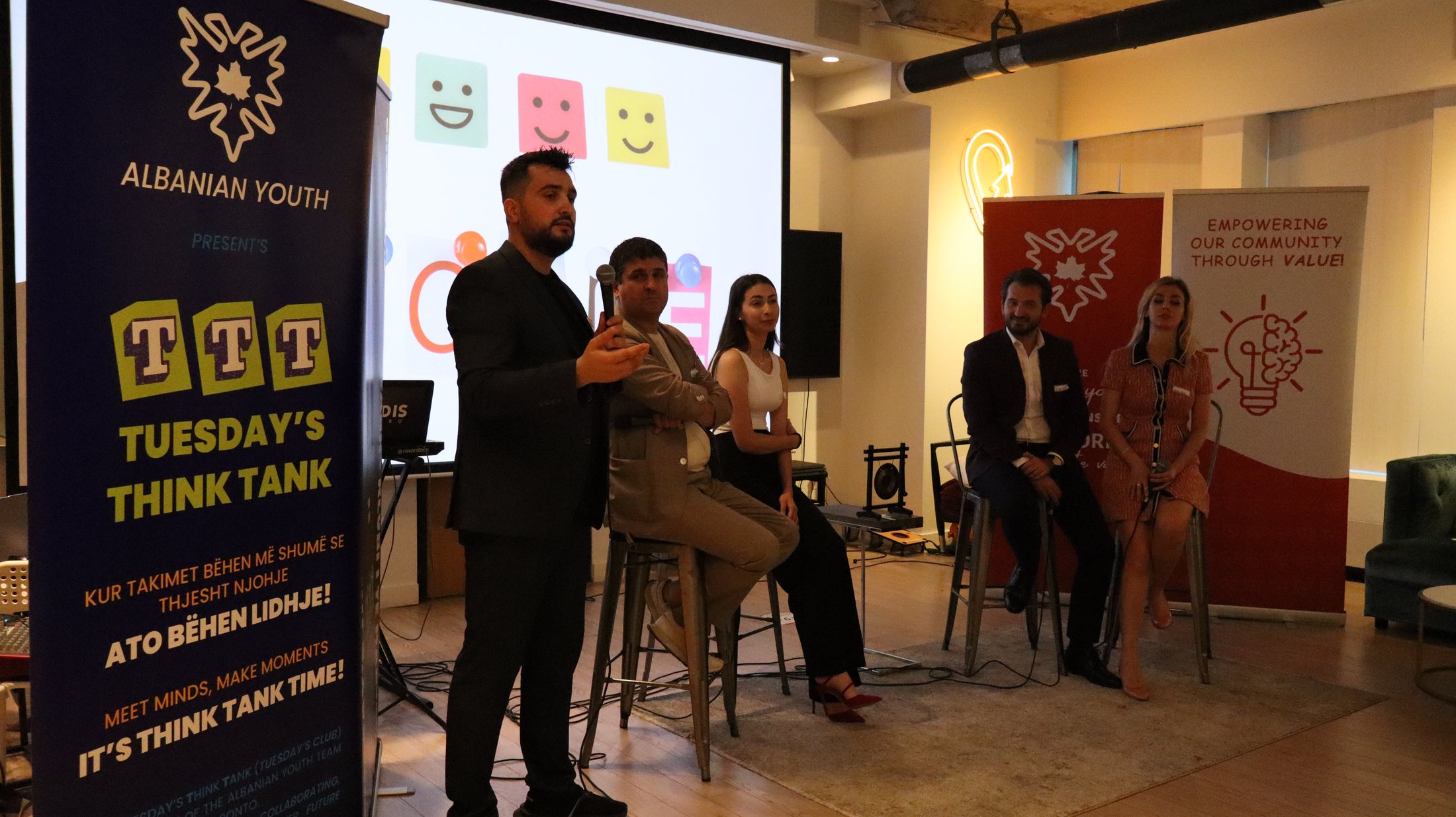 A speaker addressing a seated panel during an Albanian Youth Think Tank discussion